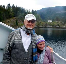 Two people on a boat in a fjord